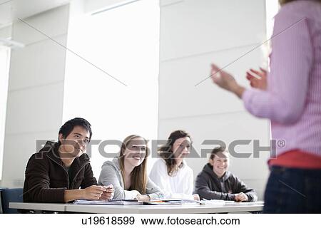 Teacher talking to students in class View Large Photo Image Stock Photo - Teacher talking to students in class. Fotosearch