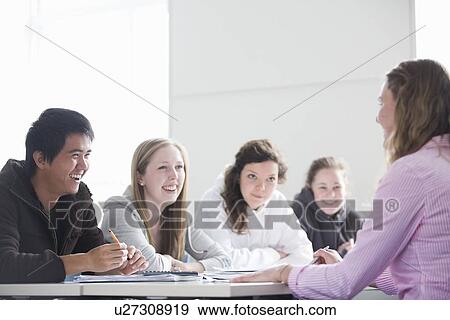 Teacher talking to students in class View Large Photo Image Stock Photo - Teacher talking to students in class. Fotosearch