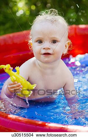 Toddler playing in inflatable pool View Large Photo Image Picture - Toddler playing in inflatable pool. Fotosearch