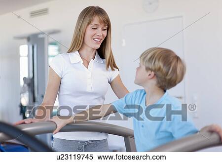 Trainer working with boy in gym View Large Photo Image Stock Photography - Trainer working with boy in gym. Fotosearch