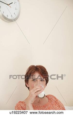 Woman drinking glass of milk View Large Photo Image Stock Photo - Woman drinking glass of milk. Fotosearch