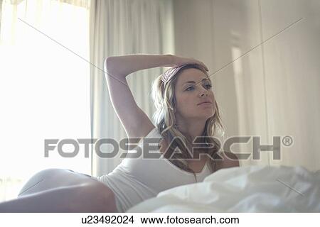 Woman in face mask laying in bed View Large Photo Image Picture - Woman in face mask laying in bed. Fotosearch