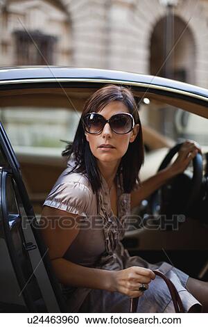 Woman peering out of car View Large Photo Image Stock Image - Woman peering out of car. Fotosearch