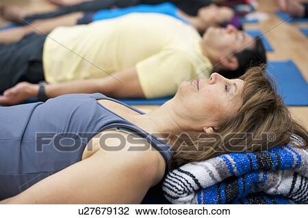 Woman practicing yoga in studio View Large Photo Image Stock Image - Woman practicing yoga in studio. Fotosearch