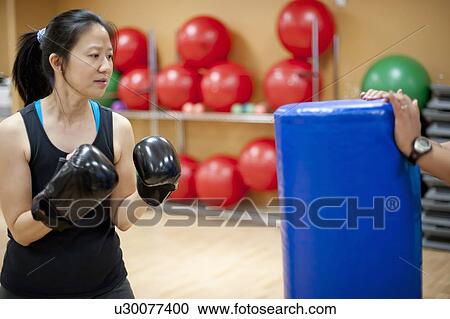 Woman punching bag in gym View Large Photo Image Stock Image - Woman punching bag in gym. Fotosearch