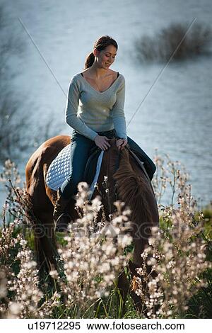 Woman riding horse in rural field View Large Photo Image Stock Photography - Woman riding horse in rural field. Fotosearch