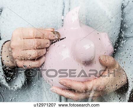 Woman saving money at rainy window View Large Photo Image Stock Photo - Woman saving money at rainy window. Fotosearch