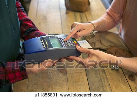 Woman shopping with credit card in store View Large Photo Image Stock Image - Woman shopping with credit card in store. Fotosearch