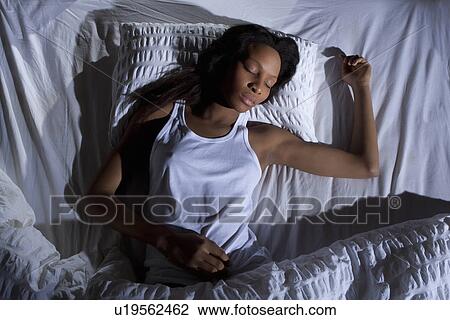 Stock Image - Woman sleeping in bed. Fotosearch