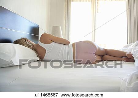 Woman sleeping on bed View Large Photo Image Stock Photo - Woman sleeping on bed. Fotosearch