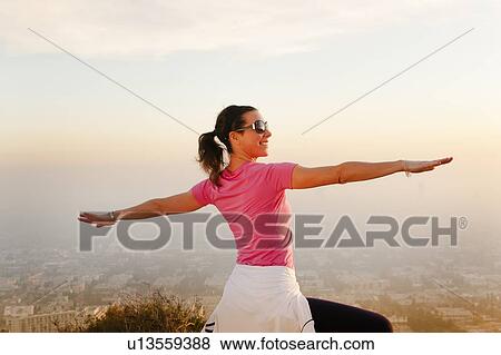 Woman stretching on hilltop View Large Photo Image Stock Photo - Woman stretching on hilltop. Fotosearch