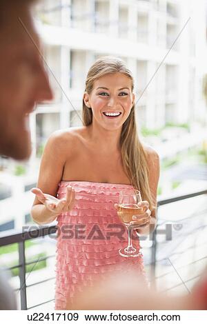 Woman talking in group at party View Large Photo Image Stock Photo - Woman talking in group at party. Fotosearch