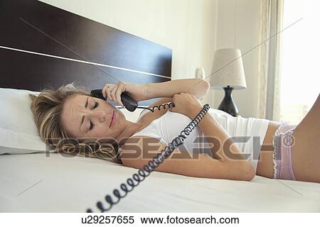 Woman talking on phone in bed View Large Photo Image Stock Photography - Woman talking on phone in bed. Fotosearch