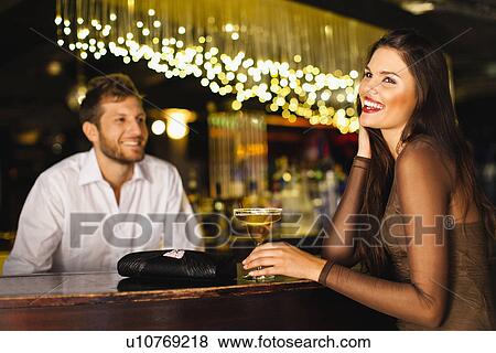 Woman talking to bartender at bar View Large Photo Image Stock Photo - Woman talking to bartender at bar. Fotosearch