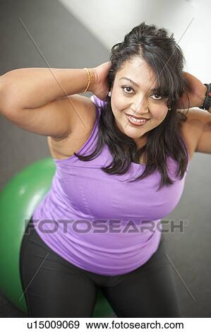 Woman using exercise ball in gym View Large Photo Image Stock Photo - Woman using exercise ball in gym. Fotosearch
