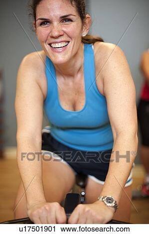 Woman using spin machine in gym View Large Photo Image Stock Image - Woman using spin machine in gym. Fotosearch