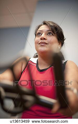 Woman using spin machine in gym View Large Photo Image Stock Photo - Woman using spin machine in gym. Fotosearch