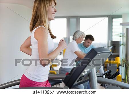 Woman using treadmill in gym View Large Photo Image Stock Photo - Woman using treadmill in gym. Fotosearch