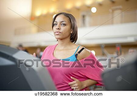 Woman using treadmill in gym View Large Photo Image Stock Photo - Woman using treadmill in gym. Fotosearch