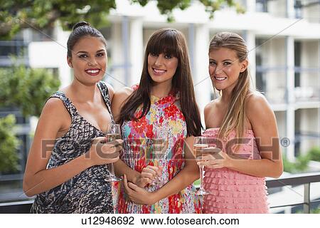 Stock Image - Women drinking champagne together. Fotosearch