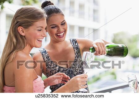 Women drinking champagne together View Large Photo Image Stock Image - Women drinking champagne together. Fotosearch
