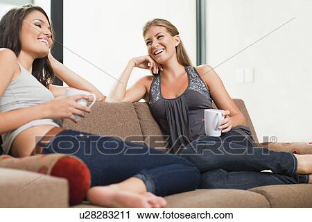 Women having coffee together on sofa View Large Photo Image Stock Image - Women having coffee together on sofa. Fotosearch