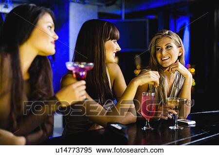 Women having drinks together at bar View Large Photo Image Stock Photography - Women having drinks together at bar. Fotosearch
