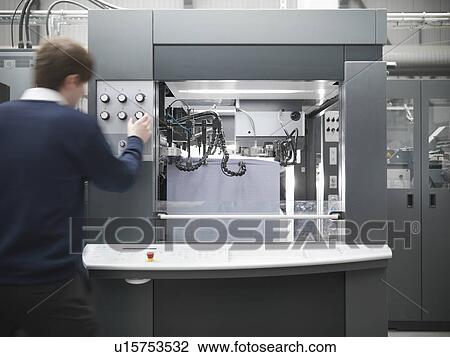 Worker adjusting printing press View Large Photo Image Stock Image - Worker adjusting printing press. Fotosearch