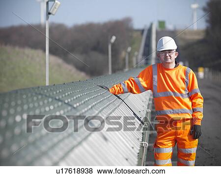 Stock Photo - Worker by conveyor at coal mine. Fotosearch