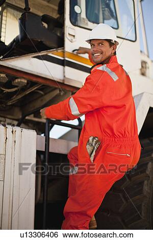 Worker climbing crane at oil refinery View Large Photo Image Stock Photograph - Worker climbing crane at oil refinery. Fotosearch