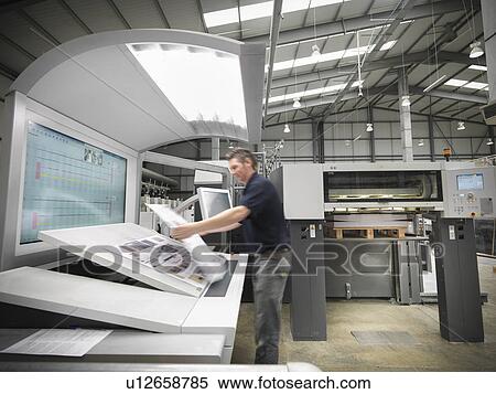 Worker examining pages in press View Large Photo Image Stock Photography - Worker examining pages in press. Fotosearch