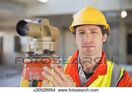 Worker using equipment on site View Large Photo Image Picture - Worker using equipment on site. Fotosearch
