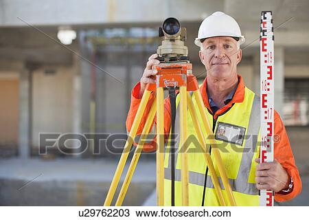 Worker using equipment on site View Large Photo Image Stock Image - Worker using equipment on site. Fotosearch