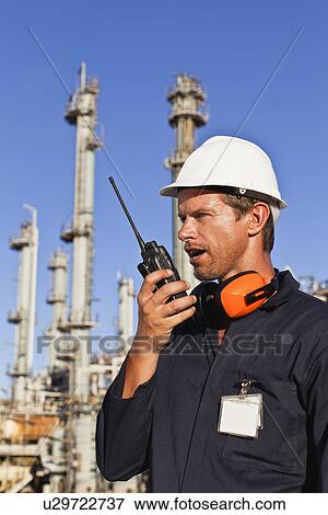 Stock Photo - Worker using walkie talkie on site. Fotosearch