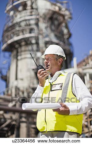 Stock Photograph - Worker with walkie talkie on site. Fotosearch