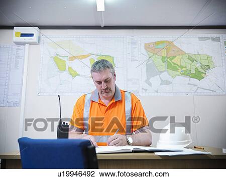Worker writing in office View Large Photo Image Stock Image - Worker writing in office. Fotosearch