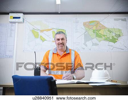 Worker writing in office View Large Photo Image Stock Image - Worker writing in office. Fotosearch