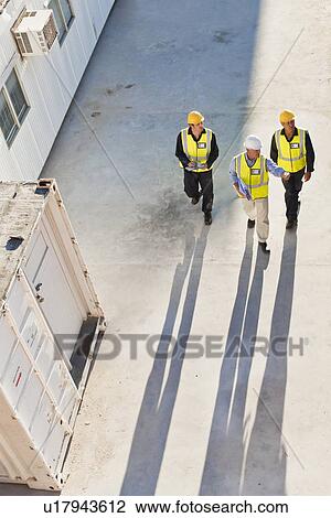 Workers casting shadows on site View Large Photo Image Stock Image - Workers casting shadows on site. Fotosearch