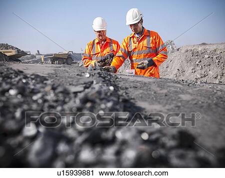 Workers inspecting coal at mine View Large Photo Image Stock Image - Workers inspecting coal at mine. Fotosearch