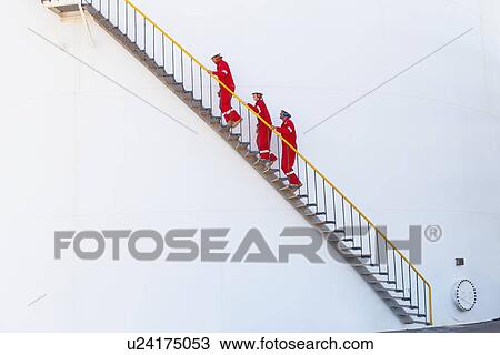 Workers on steps at chemical plant View Large Photo Image Stock Image - Workers on steps at chemical plant. Fotosearch