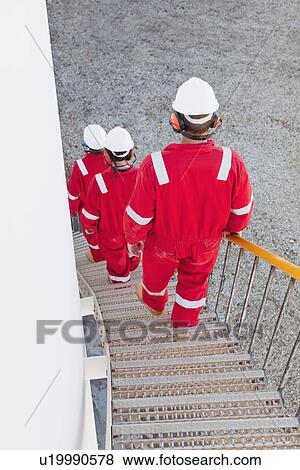 Workers on steps at chemical plant View Large Photo Image Stock Photo - Workers on steps at chemical plant. Fotosearch