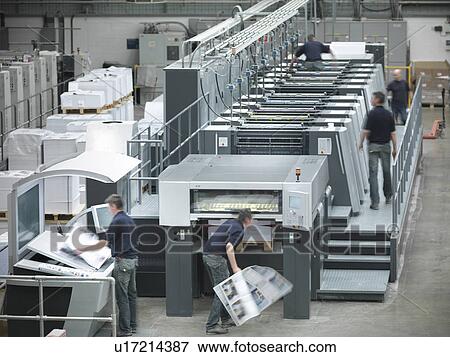 Stock Photo - Workers running printing press. Fotosearch
