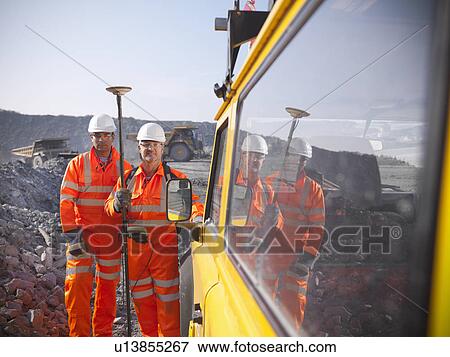Stock Photo - Workers standing at coal mine. Fotosearch
