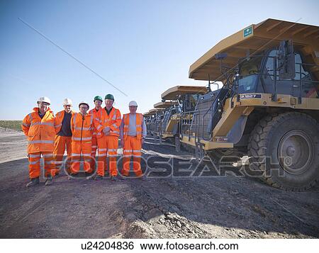 Stock Photograph - Workers standing together at coal mine. Fotosearch