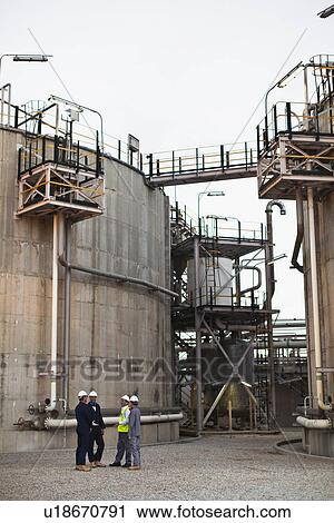 Workers talking at chemical plant View Large Photo Image Stock Image - Workers talking at chemical plant. Fotosearch