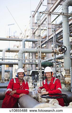 Workers talking at chemical plant View Large Photo Image Stock Photo - Workers talking at chemical plant. Fotosearch