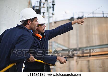 Workers talking at chemical plant View Large Photo Image Stock Photo - Workers talking at chemical plant. Fotosearch
