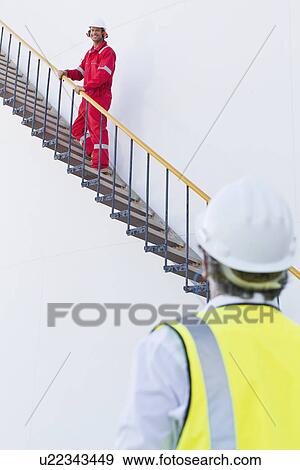 Workers talking at chemical plant View Large Photo Image Stock Photo - Workers talking at chemical plant. Fotosearch