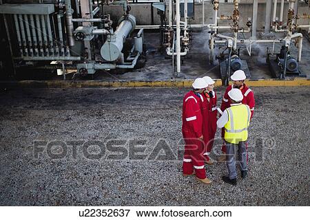 Workers talking at chemical plant View Large Photo Image Stock Photo - Workers talking at chemical plant. Fotosearch
