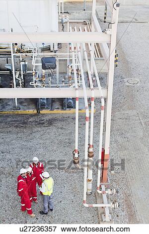 Stock Photo - Workers talking at chemical plant. Fotosearch